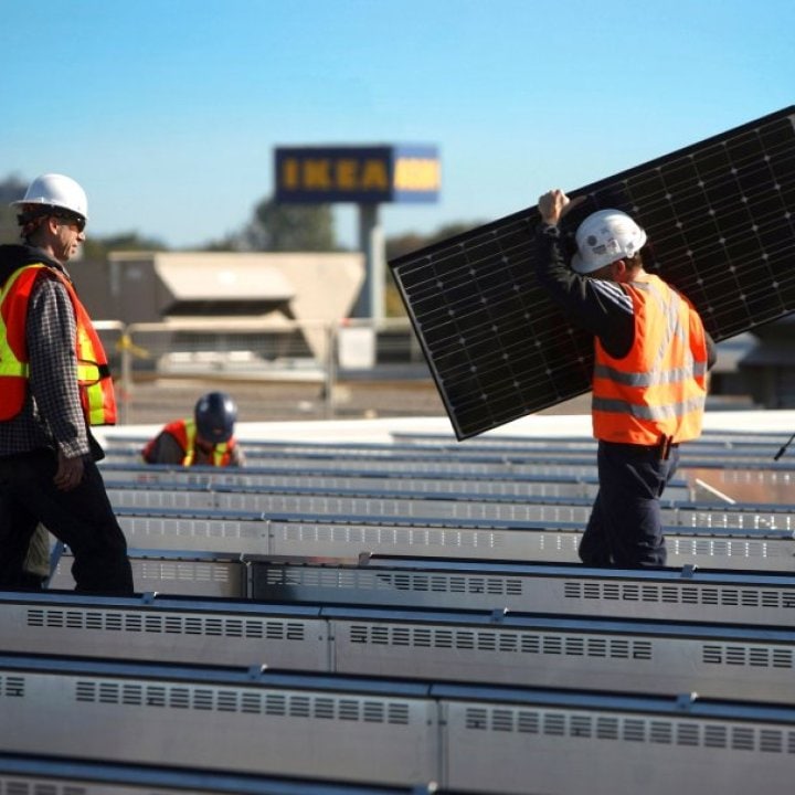 Solar panels are being mounted on an IKEA stores rooftop.